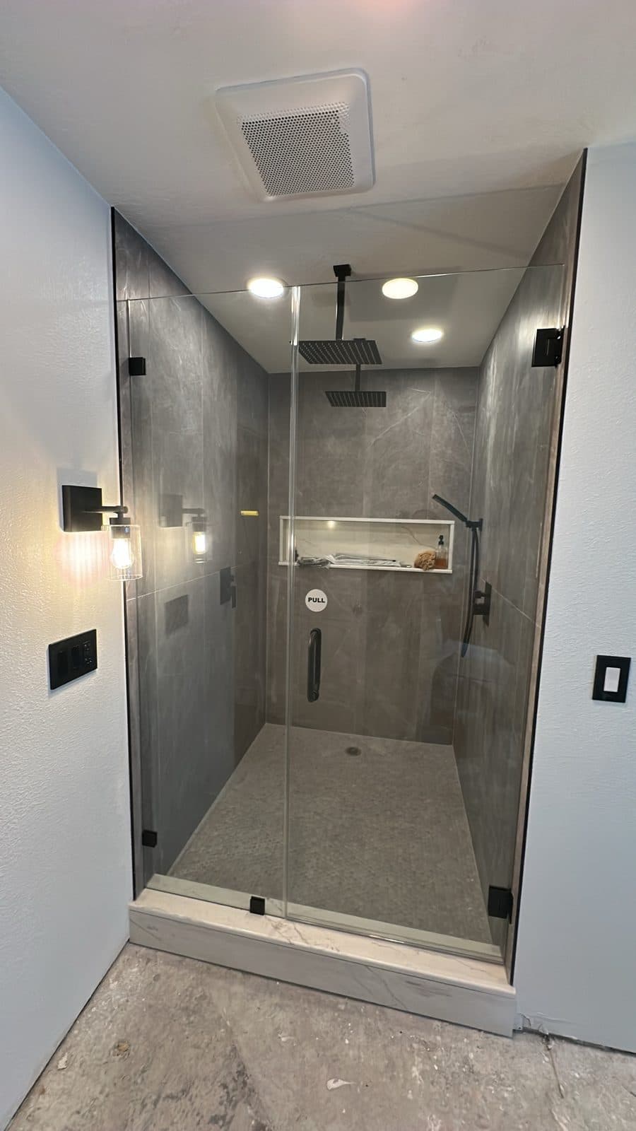 Dated shower to gray large-format with frameless glass — After
