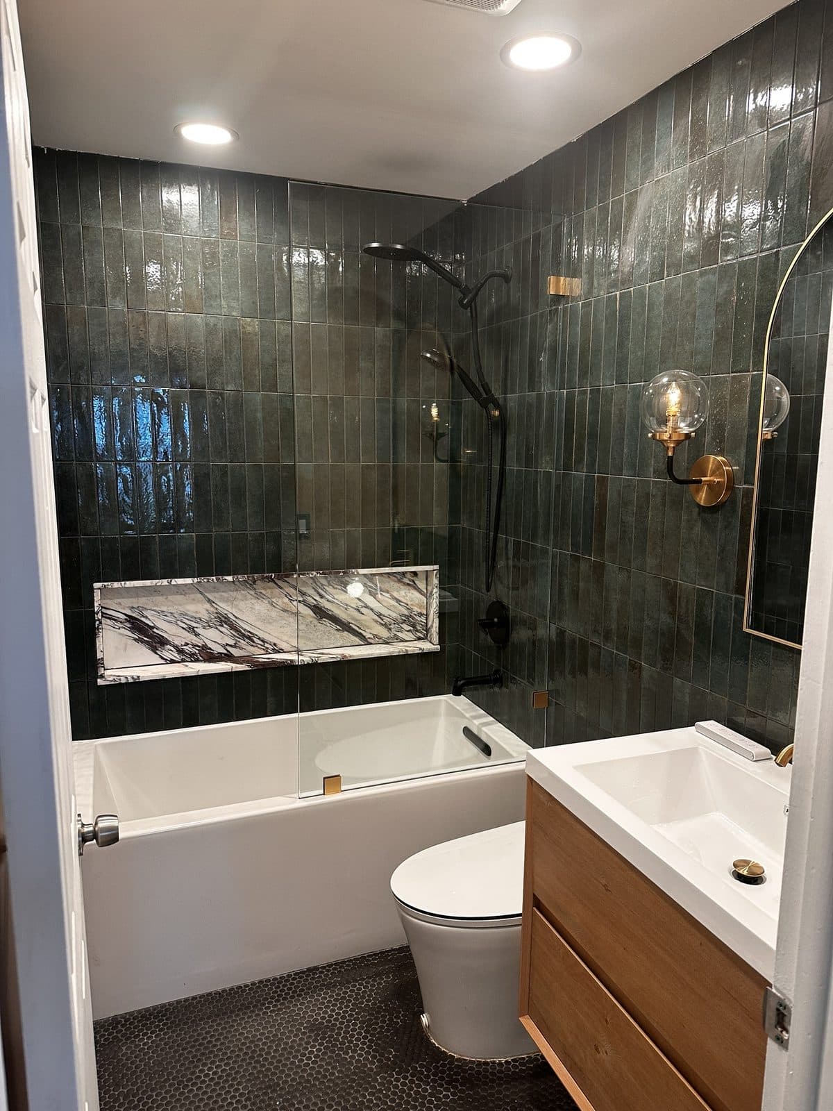 Plain fiberglass tub to green zellige tub surround — After